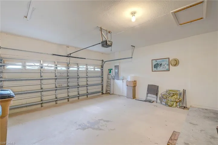 Garage with electric panel and a garage door opener