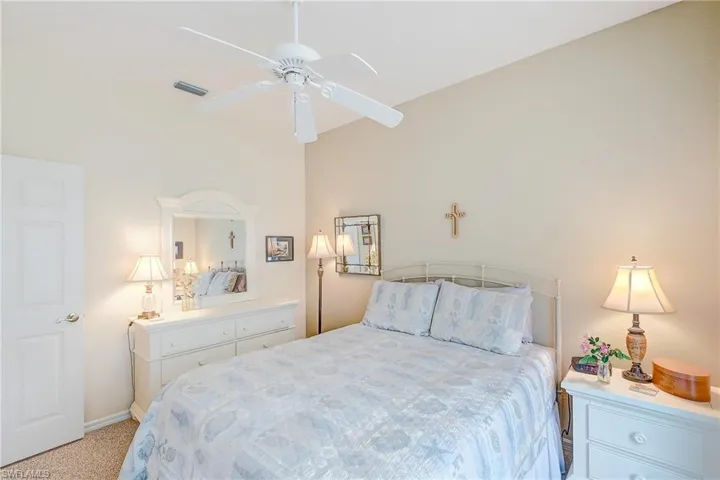 Bedroom featuring light colored carpet and a ceiling fan