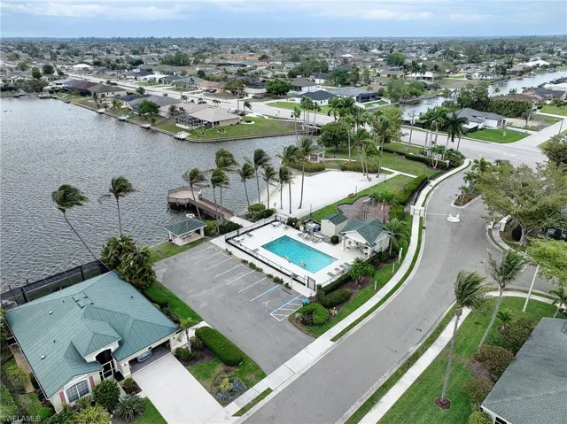 Aerial view of residential area with a large body of water and a pool