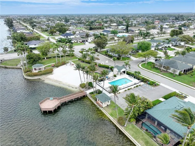 Aerial perspective of suburban area featuring a nearby body of water