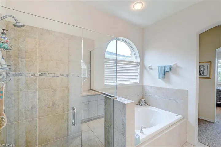 Full bath with a shower stall and a garden tub
