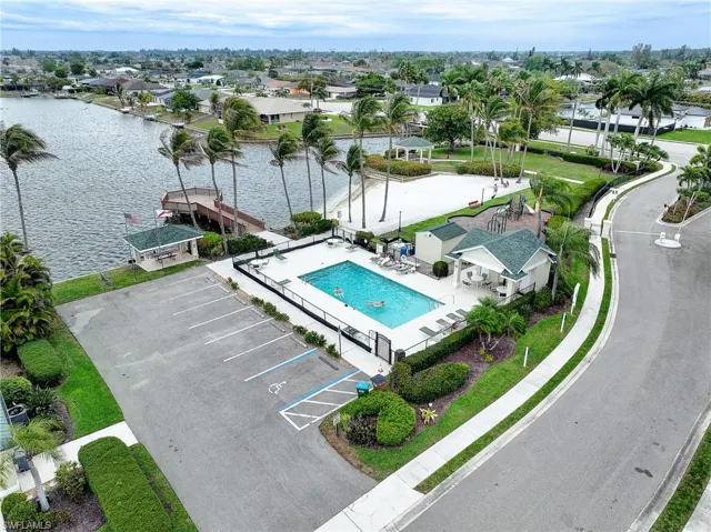 Aerial view of residential area with a pool and a nearby body of water