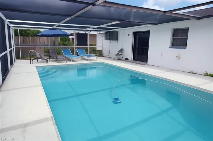Swimming pool featuring a patio area and a lanai