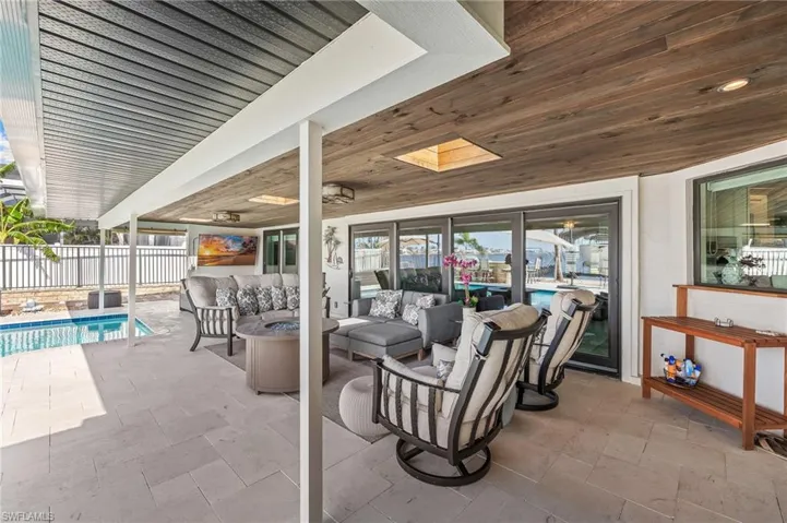 View of patio / terrace with an outdoor living space, fence, and a fenced in pool