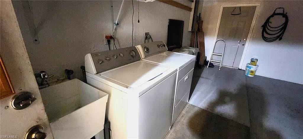 Washroom with sink and washer and dryer