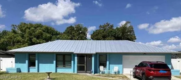 Single story home with a front lawn and a garage