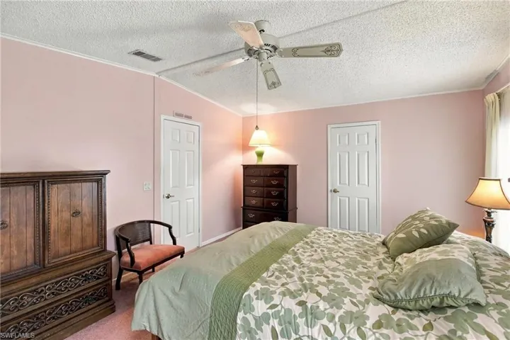 Recessed lighting, ceiling fan, and white paneled doors
