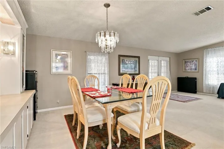 Recessed built-in cabinetry with glass-front display, overhead lighting, and counter space