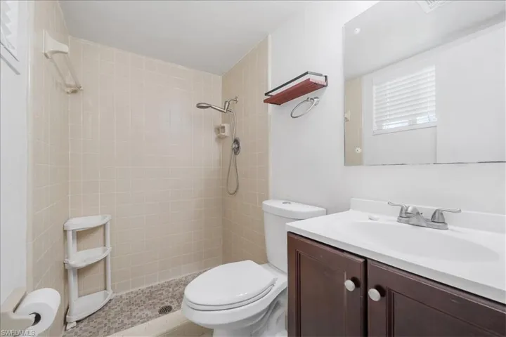 Full bathroom with vanity and a tile shower