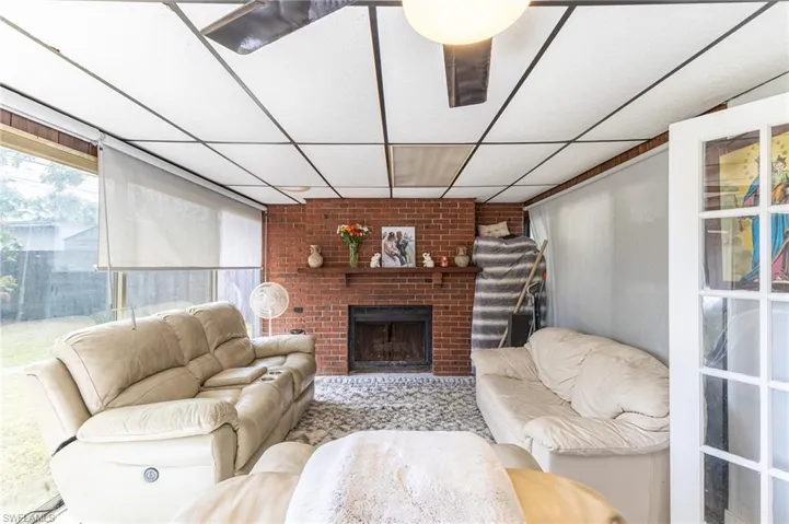 Living room with a fireplace and a paneled ceiling