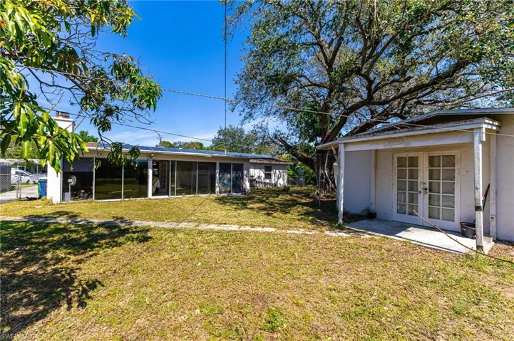 View of yard with a sunroom and french doors