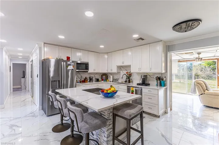 Kitchen with marble finish floor, visible vents, appliances with stainless steel finishes, and a sink