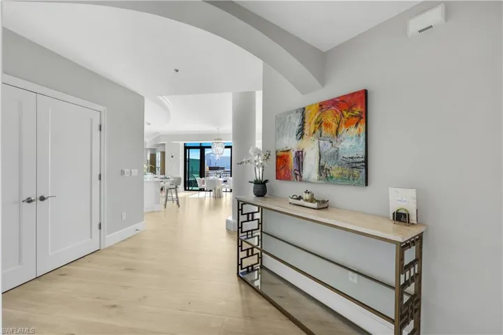 Foyerl with light wood flooring and baseboards