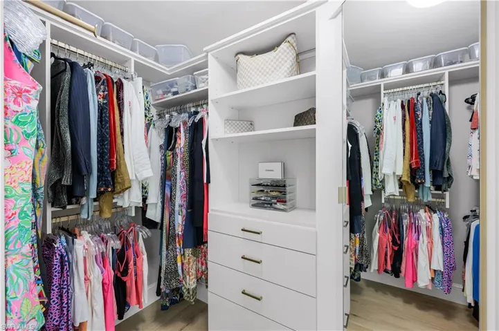 Spacious walk-in closet with built-in cabinets