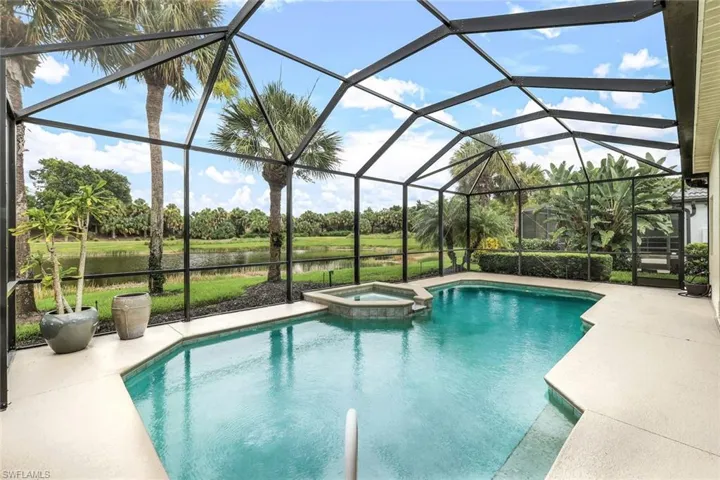 View of swimming pool with an in ground hot tub, a patio, and a lanai