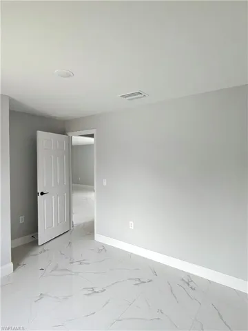Empty room with baseboards and light marble finish flooring
