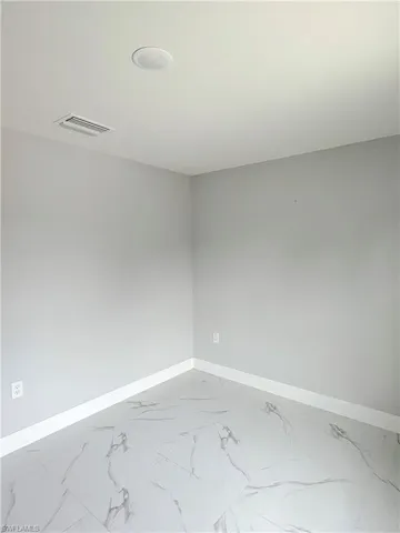 Unfurnished room featuring baseboards