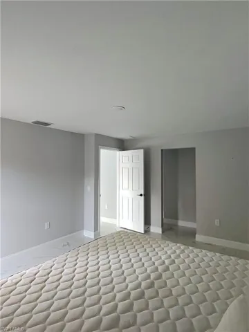Spare room with baseboards and light flooring