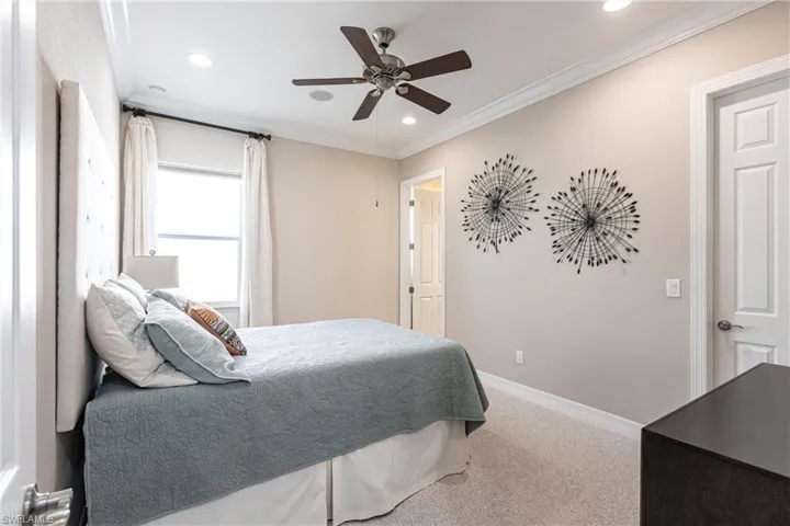 Bedroom with crown molding, light colored carpet, a ceiling fan, and recessed lighting