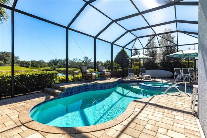 View of pool with a lanai, a patio area, and a pool with connected hot tub
