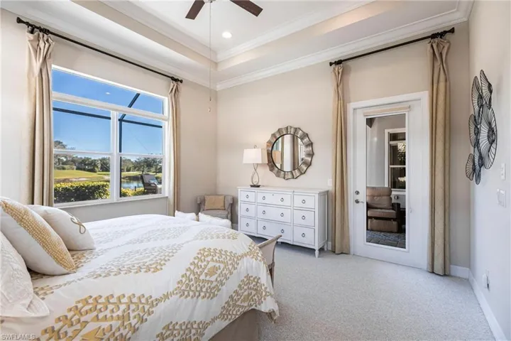 Bedroom with light carpet, a tray ceiling, ornamental molding, ceiling fan, and recessed lighting
