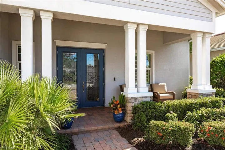 View of exterior entry with a porch, stucco siding, and french doors