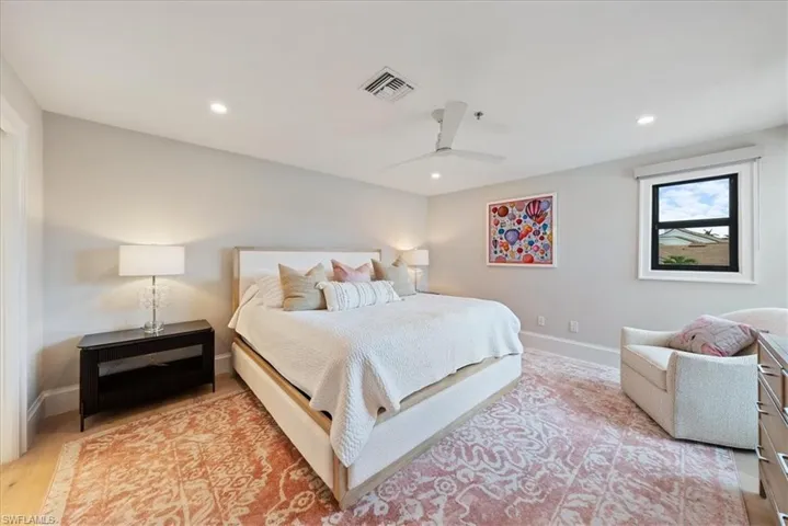 Bedroom featuring light hardwood / wood-style floors and ceiling fan