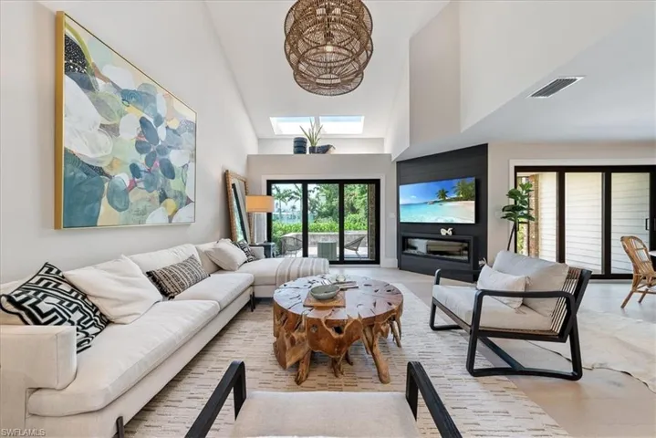 Living room featuring high vaulted ceiling