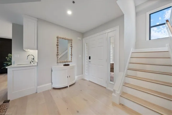 Foyer entrance featuring sink and light wood-type flooring