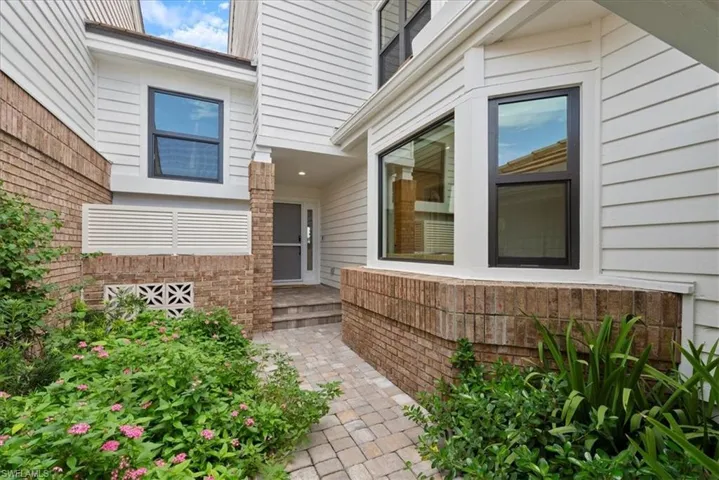 Doorway to property featuring a patio area