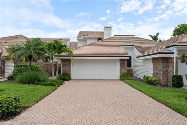 View of front of property featuring a garage and a front yard