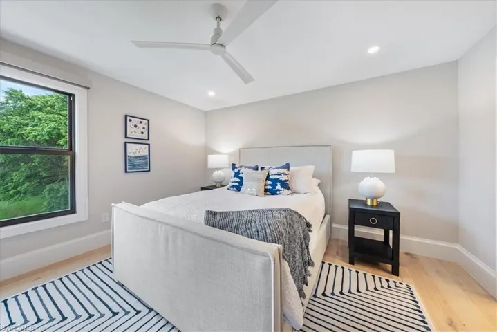 Bedroom with ceiling fan and light wood-type flooring