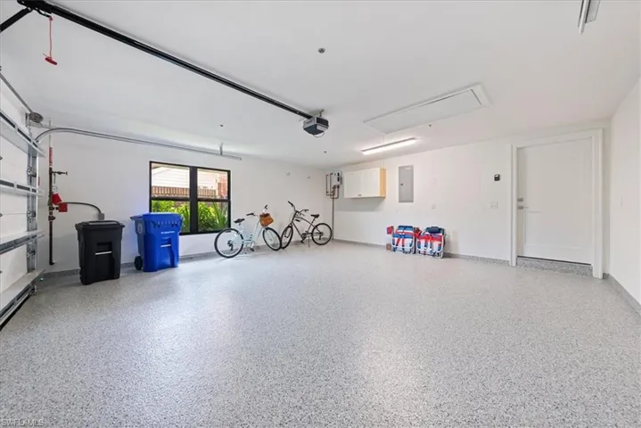 Garage with electric panel and a garage door opener
