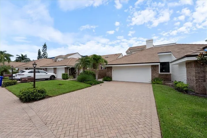 Single story home featuring a garage and a front yard