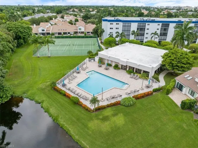 Birds eye view of property with a water view