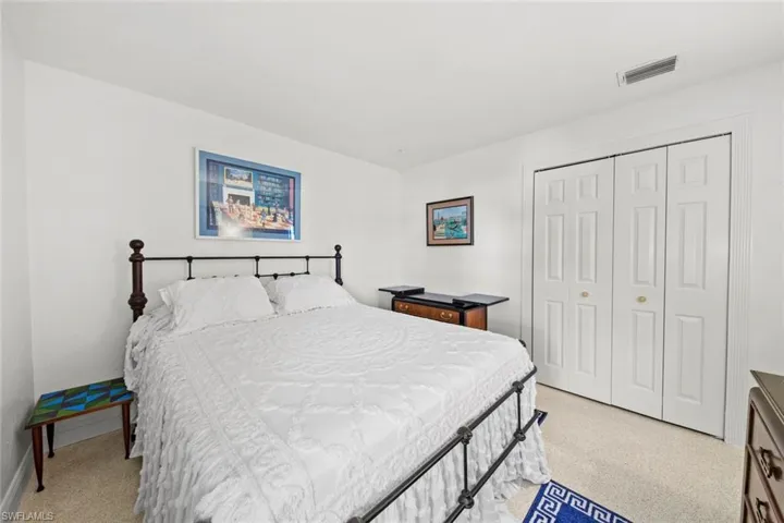 Carpeted bedroom featuring a closet