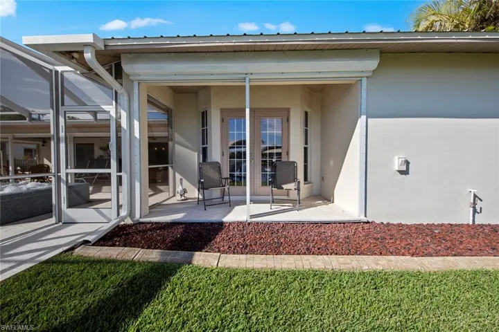 Doorway to property with a patio area