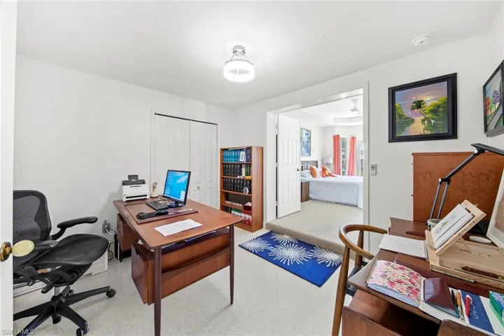 Home office featuring light colored carpet