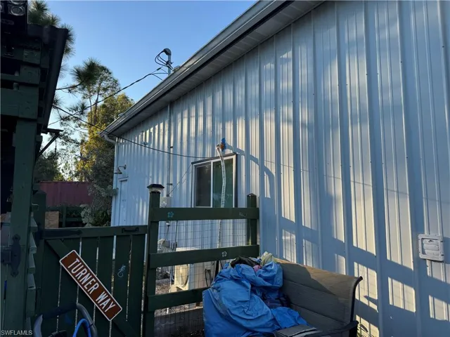 View of side of property with a gate