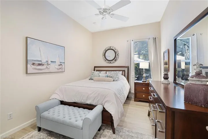 Bedroom with ceiling fan and light hardwood / wood-style floors
