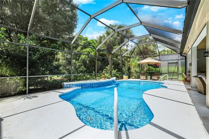 View of swimming pool featuring a lanai and a patio area
