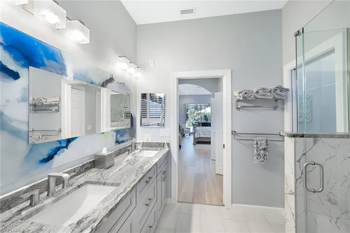Bathroom featuring vanity, hardwood / wood-style flooring, and walk in shower