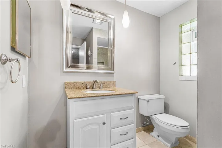 Full bathroom with vanity and light tile patterned floors
