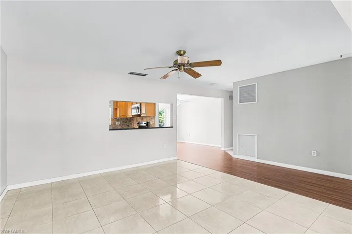 Unfurnished room with light tile patterned floors and a ceiling fan