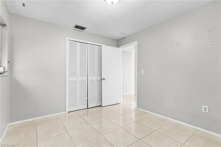 Unfurnished bedroom featuring a closet and light tile patterned floors