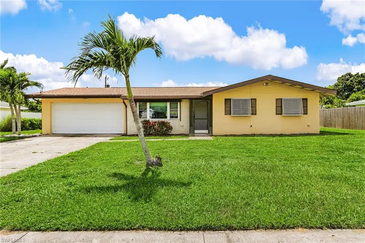 Single story home with driveway, an attached garage, and stucco siding