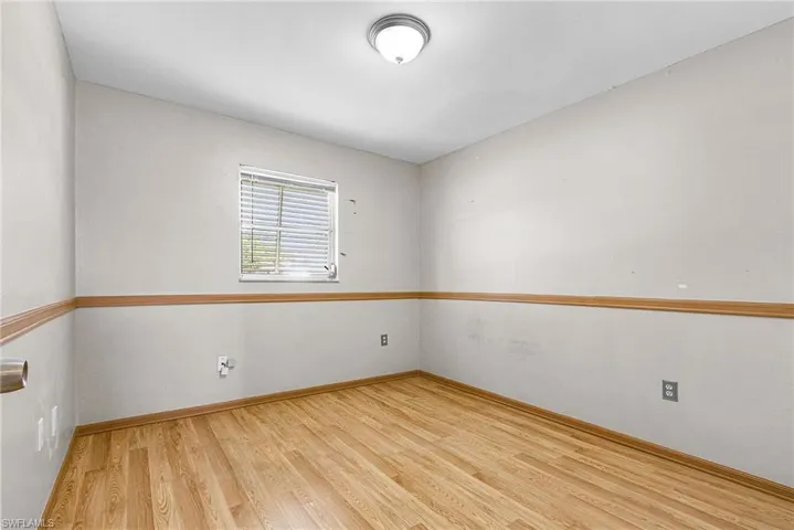 Empty room with light wood-type flooring and baseboards