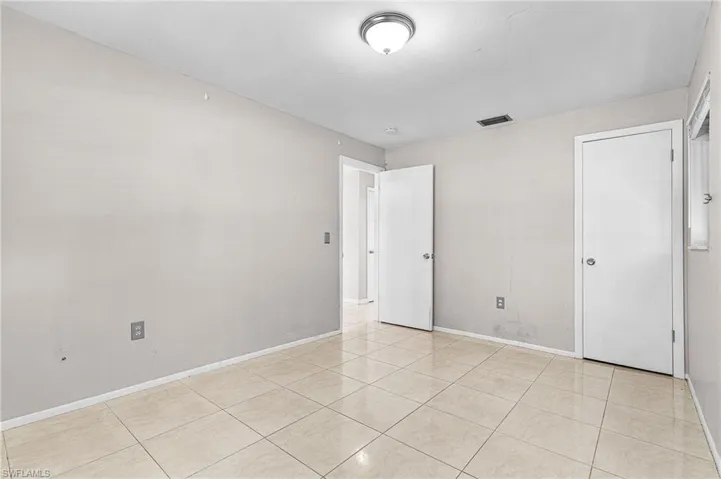 Unfurnished bedroom with light tile patterned floors