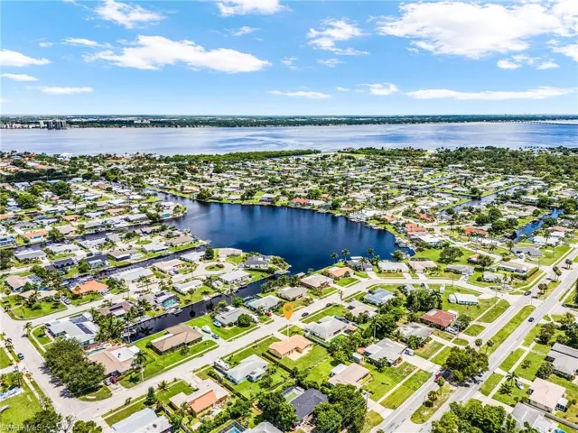 Aerial perspective of suburban area with a large body of water