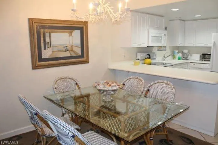 Tiled dining space featuring an inviting chandelier pre Ian